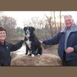 Joyce, Bill, and their beloved dog Andy next to Sycamore Creek near Hague Nature Preserve