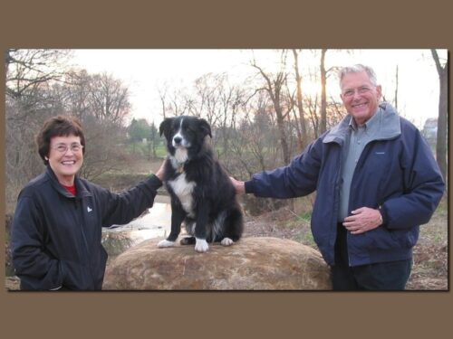 Joyce, Bill, and their beloved dog Andy next to Sycamore Creek near Hague Nature Preserve